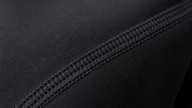 Close-up of a flatlock seam stitched flush against workout leggings fabric to reduce chafing