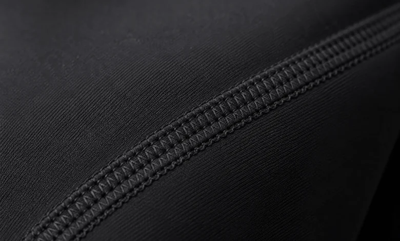Close-up of a flatlock seam stitched flush against workout leggings fabric to reduce chafing