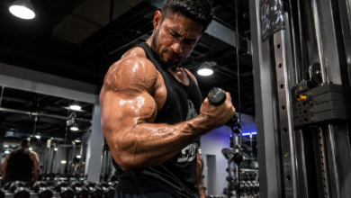 Man showing a muscle pump in his arm while doing a bicep curl, illustrating what is a pump in the gym