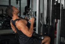 Man performing a close grip lat pulldown on a cable machine to train his back and biceps
