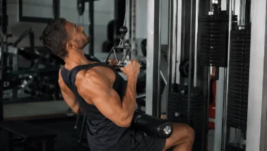 Man performing a close grip lat pulldown on a cable machine to train his back and biceps