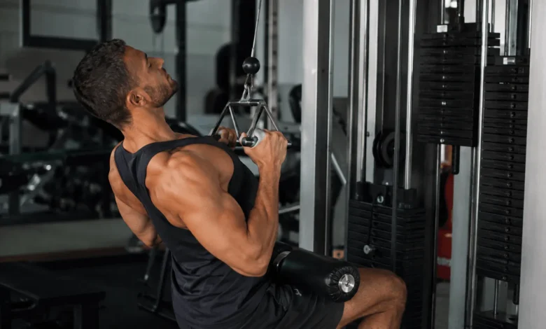 Man performing a close grip lat pulldown on a cable machine to train his back and biceps