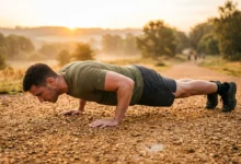 man performing push-up during military calisthenics workout outdoors