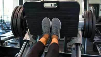 Feet positioned low and narrow on a leg press machine for a quad-focused leg press