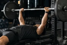 Lifter performing a barbell bench press as part of a push pull legs upper lower split